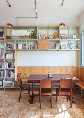 Không gian nội thất Tempo Nexus Library với gạch bông cũ được phục hồi, kệ gỗ và ánh sáng tự nhiên trong chung cư Lê Ngọc, 130 Pasteur TP.HCM - 9