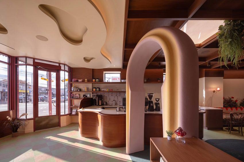 Không gian nội thất gỗ walnut tại Willow Play Cafe ở Toronto với cầu trượt đỏ và khu vui chơi tích hợp cạnh khu cà phê - 1